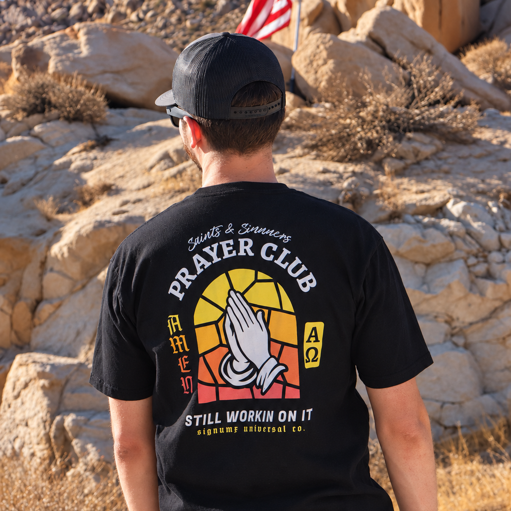 Man wearing the Saints & Sinners Prayer Club Catholic T-shirt – SIGNUMX lifestyle photo