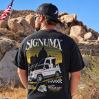 Man wearing washed black Vatican City Racing Catholic shirt, back racing graphic